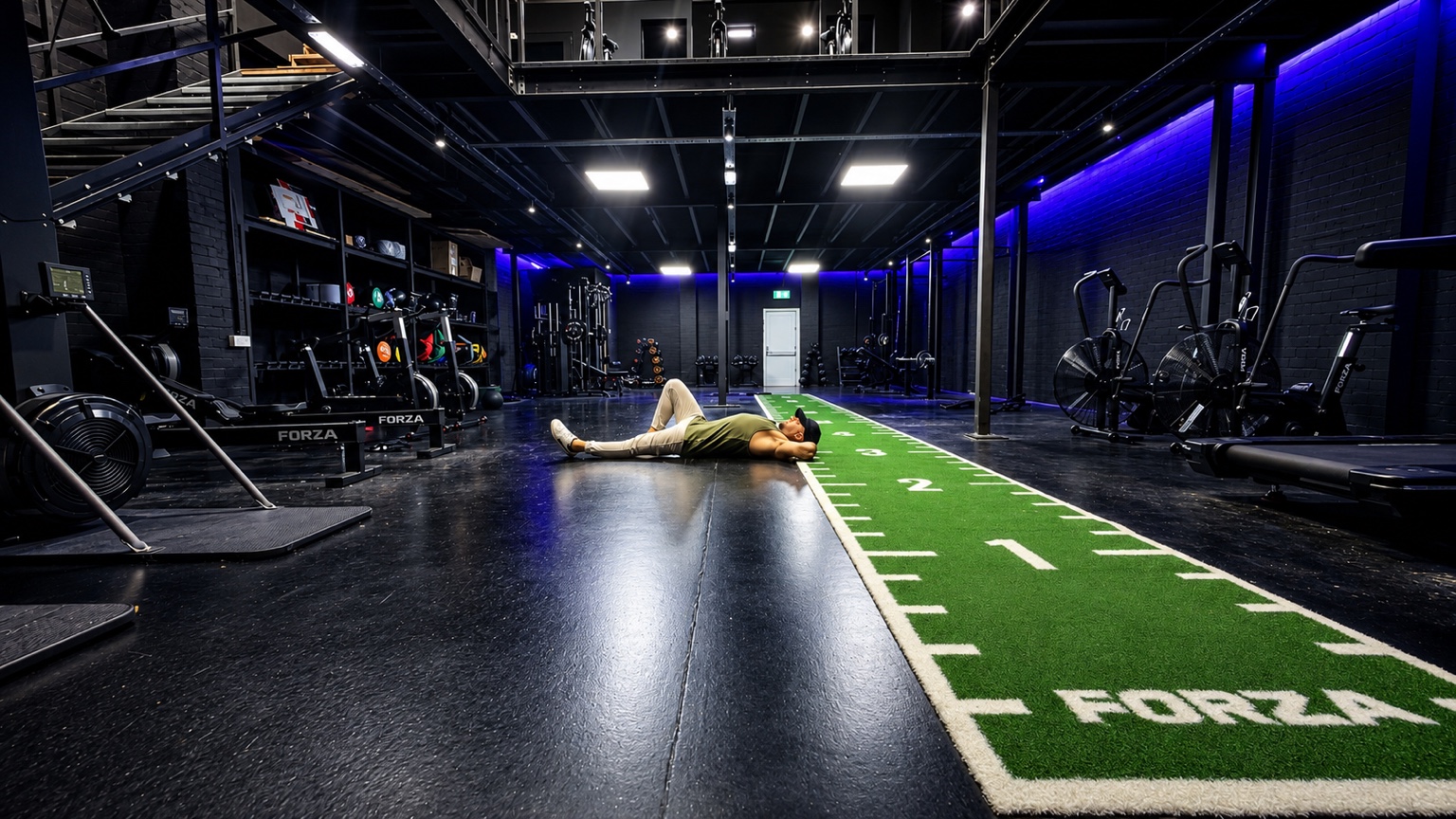 Jamie Lee lying comfortably on the floor inside JLT Fitness Studio.